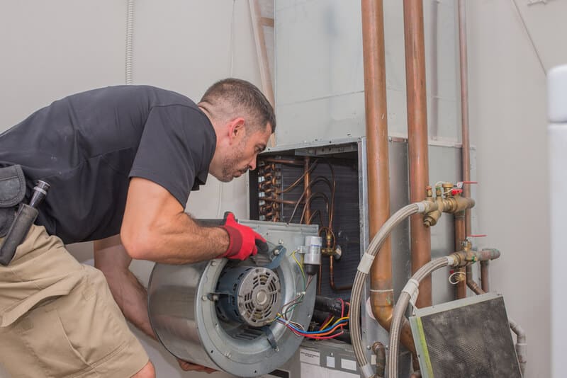 Brewer technician installing air handler in southport home